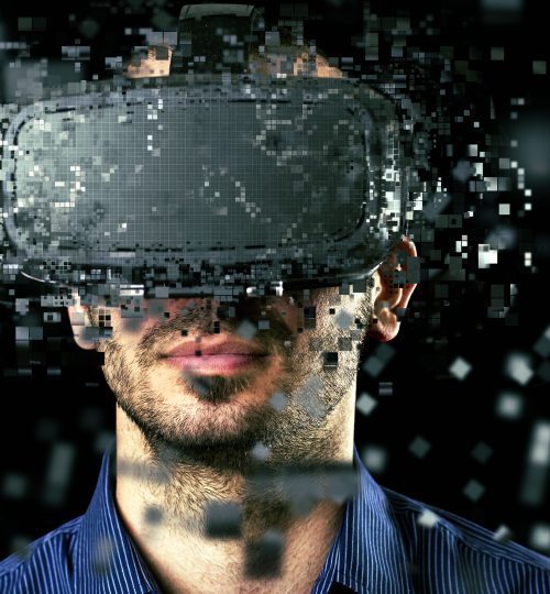 Man wearing virtual reality headset on dark background